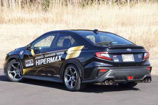 HKS Legamax Sport catback exhaust system installed on a 2021 Subaru WRX, showcasing polished stainless steel mufflers and piping.