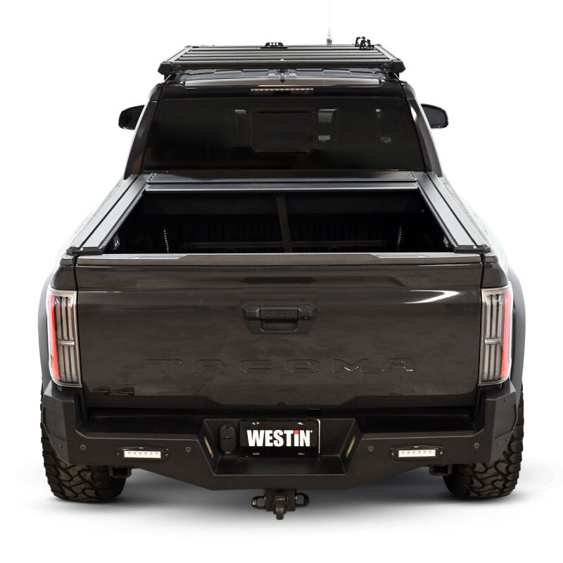 Westin 24-26 Toyota Tacoma black manual roll-up tonneau cover on 5ft truck bed, designed for easy retractable use.