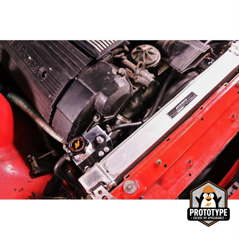 Mishimoto aluminum coolant expansion tank for BMW 3 Series E92 E93 92-99, close-up of the polished coolant reservoir with mounting features.