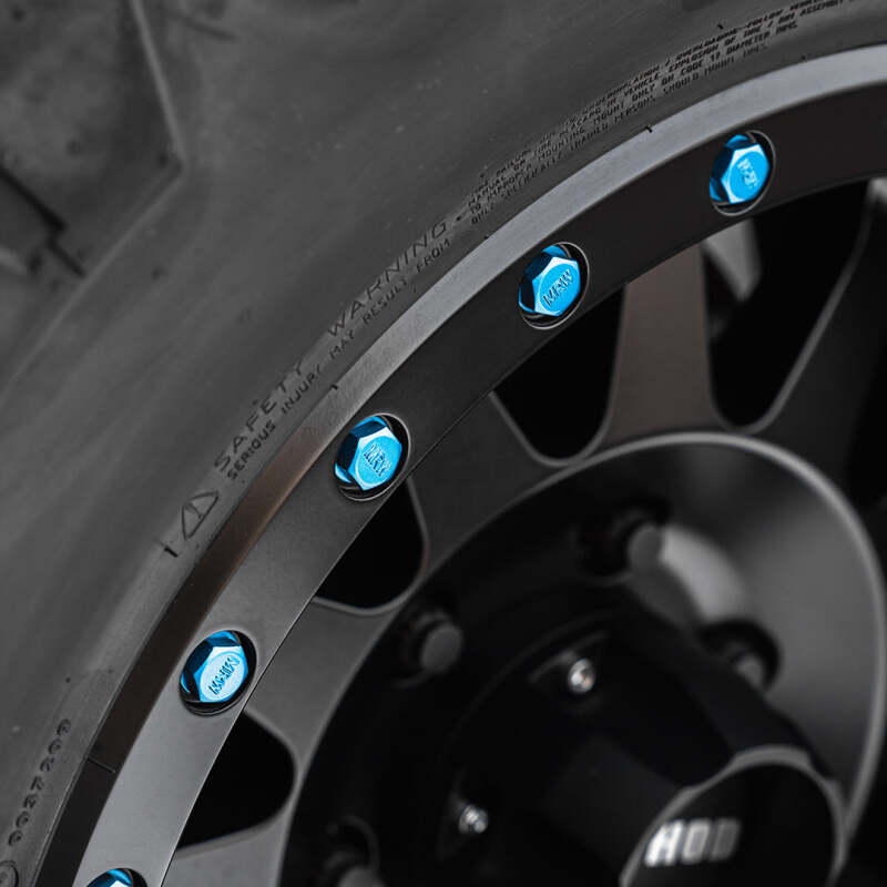 Method Lip Bolt wheel bolts in matte blue for street use, part of the Method Wheels kit, shown on a vehicle wheel.