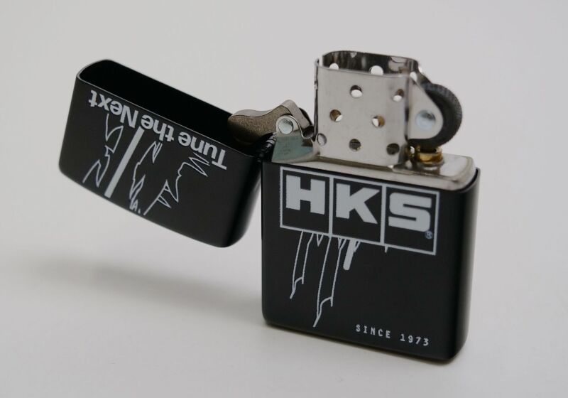 HKS Zippo lighter TTN with sleek metal design and classic flip-top lid, featuring the HKS branding on the lighter surface.