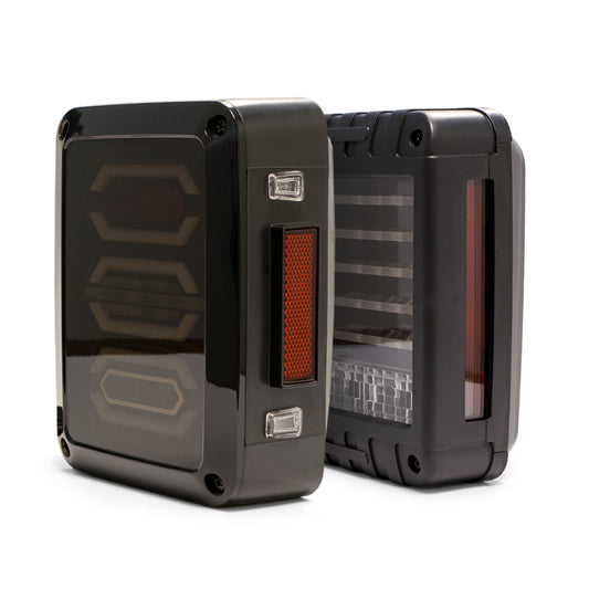 DV8 Offroad Jeep Wrangler JK octagon LED tail light showing bright red and clear lens with black housing, mounted on vehicle rear.