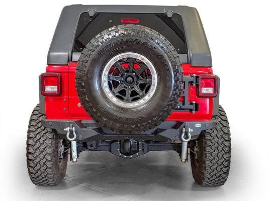 DV8 Offroad Chase Rack tire carrier for 2018+ Jeep Wrangler, sturdy off-road vehicle accessory with mounted tire holder.