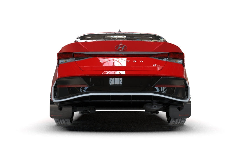 Rally Armor black mud flaps with grey logo installed on a Hyundai Elantra N/N Line, protecting wheel arches from debris.