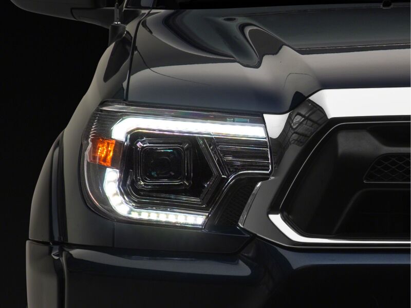 Raxiom 12-15 Toyota Tacoma Axial Series projector headlights with chrome finish and clear lens, designed for enhanced visibility.