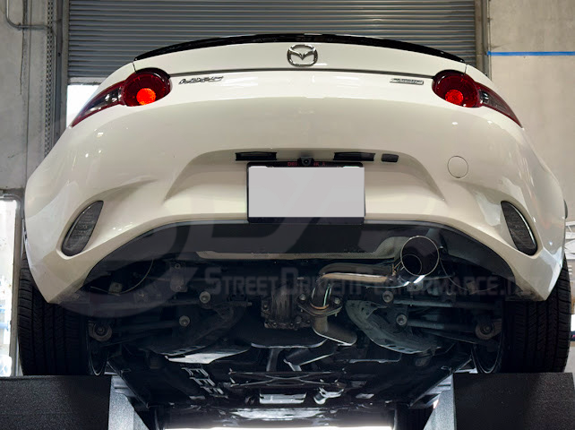 Mazda MX-5 Miata ND 2016-2025 Street Driven Performance axle back exhaust with 4-inch burnt or chrome tips, rear view.