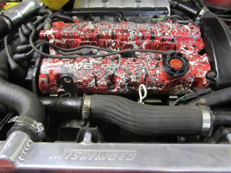 Mishimoto aluminum radiator for 1991-1999 Mitsubishi 3000GT Turbo, showing the sleek, silver design and cooling fins.