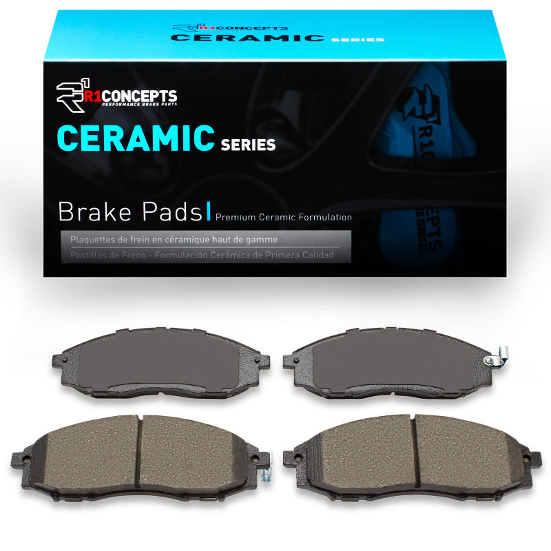 R1 Concepts Nissan XTerra front ceramic brake pads, OE type, installed on vehicle, showing the brake pad design and materials.