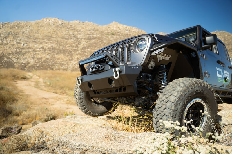 DV8 Offroad Jeep Wrangler JL/JT front bumper sway-bar disconnect motor skid plate showing durable metal construction and mounting points.