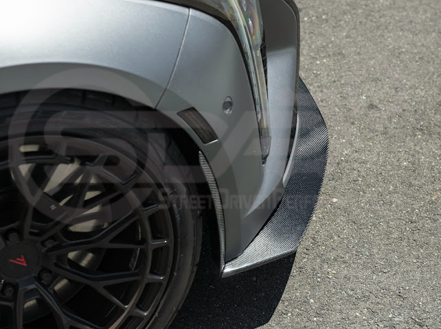 Cadillac CT5-V Blackwing factory OEM style carbon fiber front lip splitter and wheel arches, ground effects for enhanced performance and style.