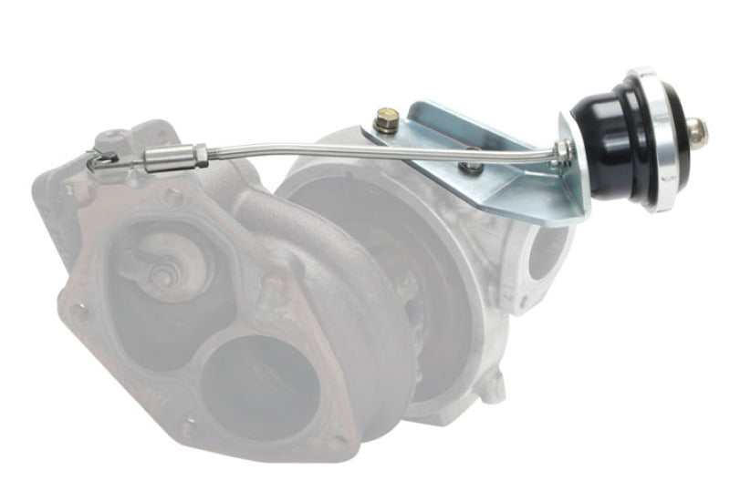 Turbosmart IWG75 black internal wastegate actuator installed on Mitsubishi EVO 9, showing the compact metal component