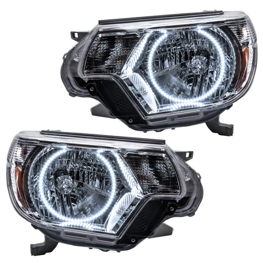 Oracle Toyota Tacoma headlights with white SMD LED bulbs, showcasing the front view of the headlights for model years 2012-2015.