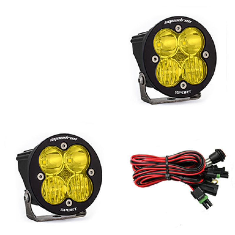 Baja Designs Squadron R Sport LED light pods in amber, driving/combo pair, mounted on a vehicle for off-road lighting.