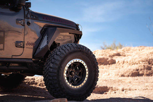 Black DV8 Offroad Jeep Wrangler JL 2018+ front inner fenders, wheel well liners, showing durable plastic construction.