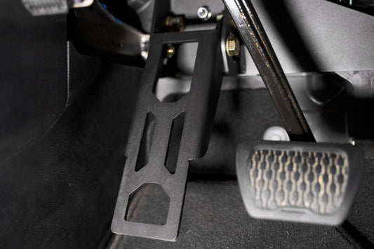 DV8 Offroad Jeep Wrangler JL pedal covers, adjustable dead pedal with textured surface for enhanced grip and off-road style.