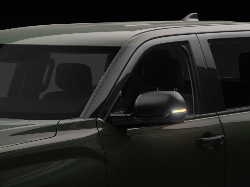 Raxiom 22-26 Toyota Tundra side mirrors with clear sequential LED mirror lights, showcasing the LED light pattern and mirror design.