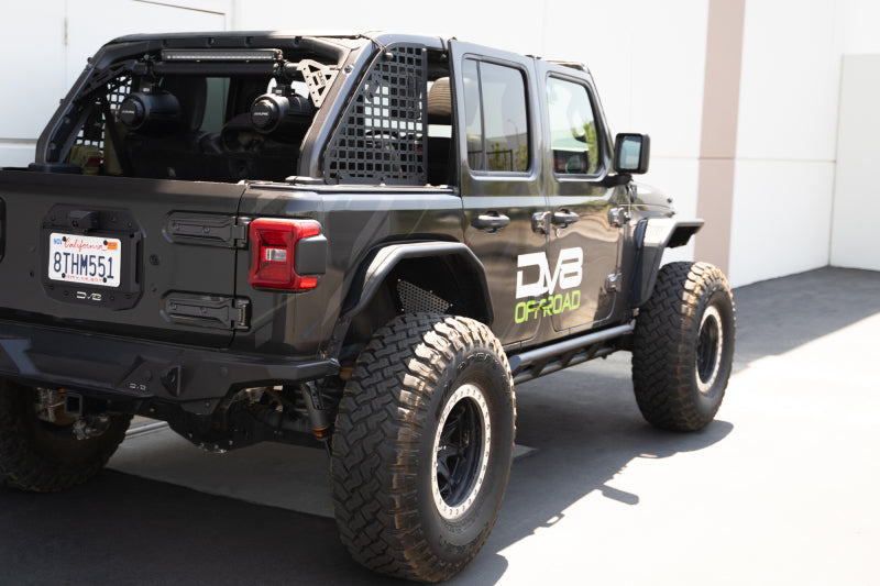 DV8 Offroad 18-23 Jeep Wrangler JL 4-door FS-15 Series rock sliders mounted on vehicle body for protection.