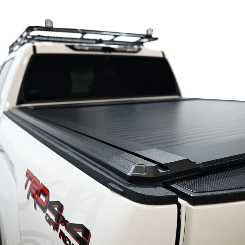Westin manual retractable tonneau cover in black on a 22-26 Toyota Tundra with a 5.5ft bed, roll-up style for bed protection.