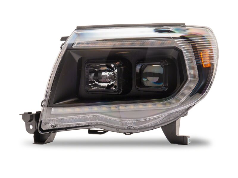 Raxiom Toyota Tacoma 2005-2011 Axial Series projector headlights with black housing and clear lens, showcasing sleek design and bright illumination.