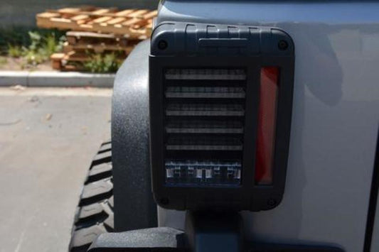 DV8 Offroad Jeep Wrangler JK horizontal LED tail light, clear lens with red and amber LEDs for rear vehicle lighting.