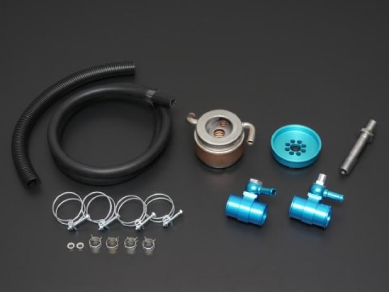 Cusco water to oil engine oil cooler for Subaru BRZ, Toyota 86, and Scion FR-S, showing the compact metal cooling unit with hoses