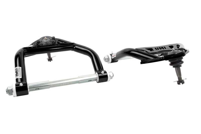 UMI Performance GM A-Body tubular upper and lower front control arms with Delrin bushings on a car suspension system.
