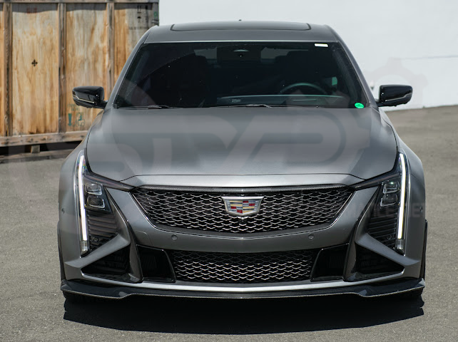 Cadillac CT5-V Blackwing factory OEM style carbon fiber front lip splitter and wheel arch extensions for ground effects.