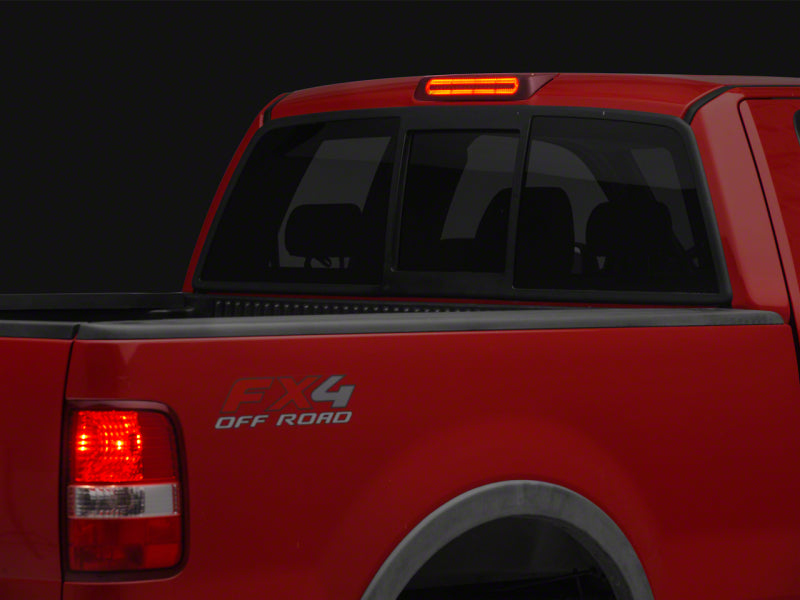 Raxiom Ford F-150 Axial Series LED third brake light mounted on truck rear with clear lens and bright LED bulbs.