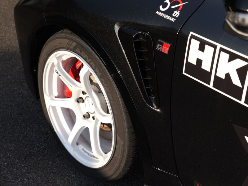 HKS GR Corolla GZEA14H fender molding from body kit, close-up of black plastic trim on the car's front fender.