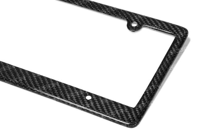 Seibon carbon fiber license plate frame with four holes for easy mounting, showcasing sleek black carbon fiber finish.