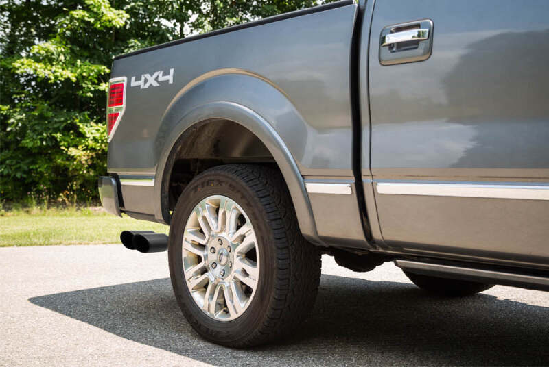 Roush black tip cat back exhaust system for Ford F-150 Raptor 6.2L, side exit design, shiny metal finish, installed on truck.