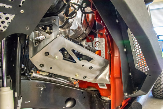 DV8 Offroad Jeep JL/JT engine bay compressor mount for air suspension, shown installed in the engine compartment.