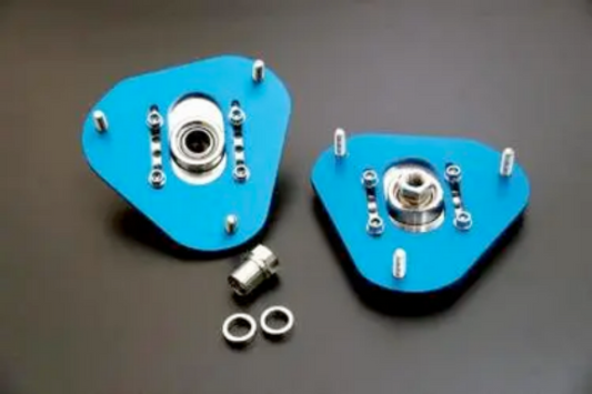 Cusco upper mount pillowball front shock mount for Nissan 350Z N15, showing the adjustable camber plate with metal components and mounting bolts.