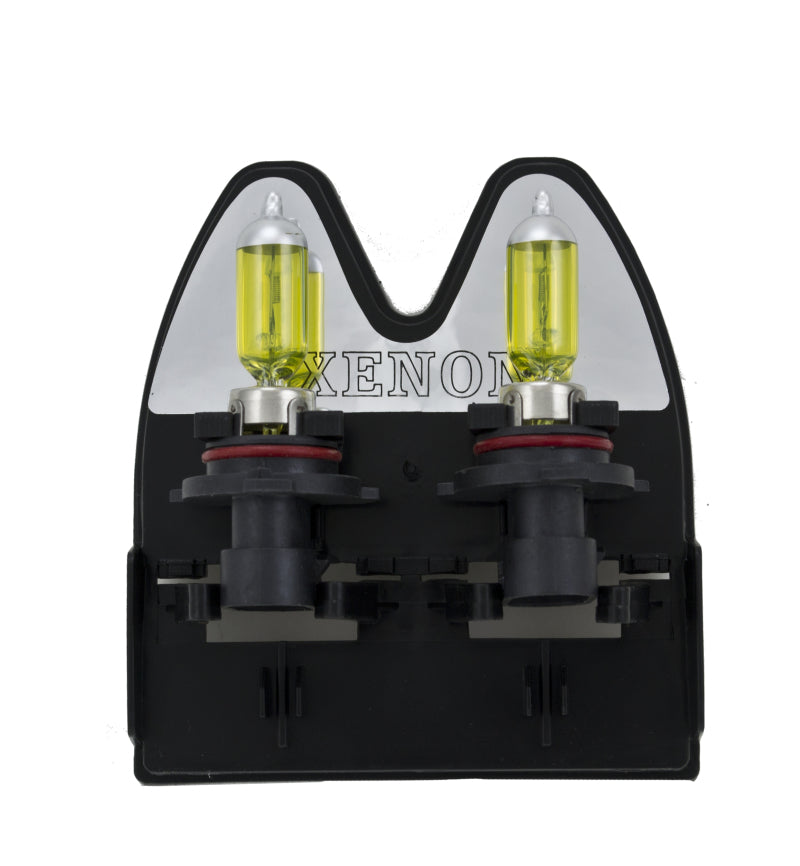 Hella 9006XS 12V 55W Xen Pure yellow bulbs, two automotive headlight bulbs with yellow tint and clear glass.