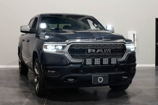 Diode Dynamics Stage Series ditch light bracket kit mounted on a 2019-present Ram truck for off-road lighting.