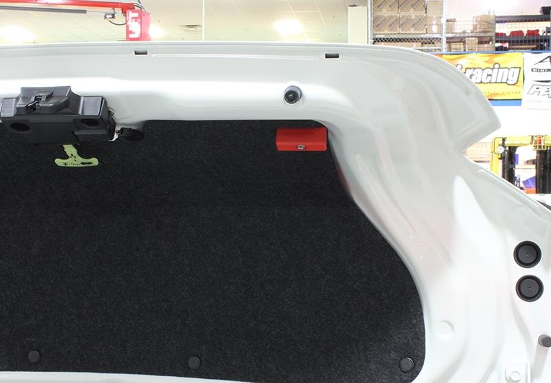 Red Perrin Performance trunk handle for Subaru BRZ, Toyota GR86, and 86/FR-S hatchbacks, mounted on vehicle trunk.