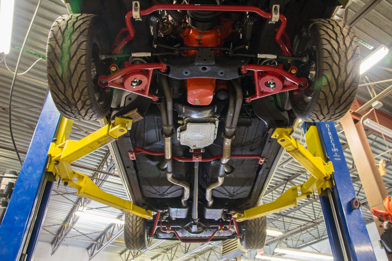 UMI Performance tubular front lower control arms for G-Body and S10 trucks, featuring Delrin bushings for improved handling.