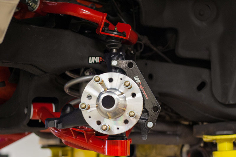 UMI Performance tubular front lower control arms with Delrin bushings for 78-88 G-Body and S10 trucks, showcasing the black metal construction.