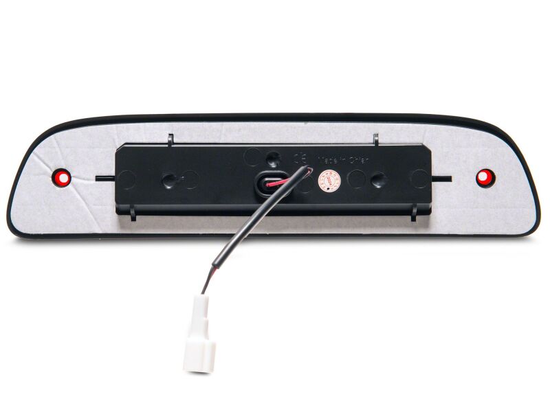 Red Raxiom Axial Series LED third brake light for 2005-2015 Toyota Tacoma, mounted on the vehicle's rear.