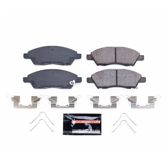 PowerStop Z23 Evolution sport brake pads with hardware installed on a Nissan Micra front brake assembly.