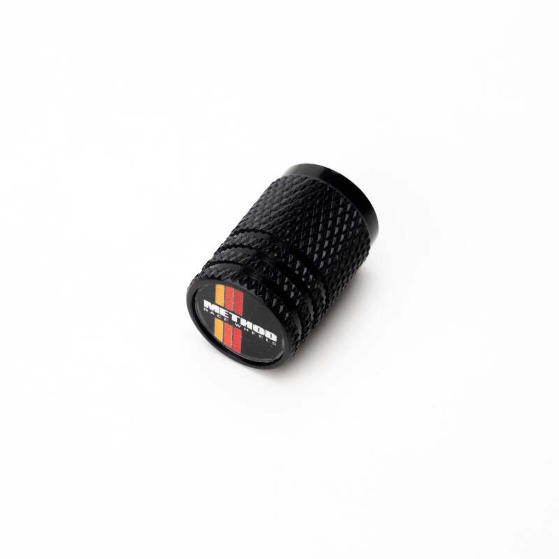 Set of four Method Wheels valve stem caps with classic stripe design, made for vehicle tire valves.