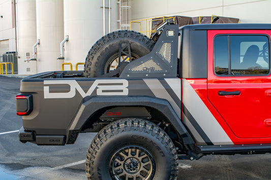 DV8 Offroad Jeep Gladiator chase rack with universal stand-up in-bed tire carrier, mounted inside the truck bed.