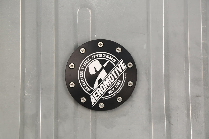 Aeromotive Stealth Gen 2 Fuel Tank for 1964-1968 Ford Mustang, showing the black fuel tank with inlet and outlet fittings.