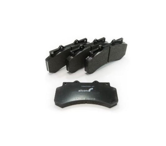 Alcon 2010+ Ford F-150 front performance brake pad set showing black brake pad components with metal backing plates.