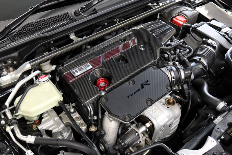 HKS dry carbon fiber engine cover for Honda Civic Type R FL5 and FK8 models, showcasing a sleek, lightweight engine accessory.