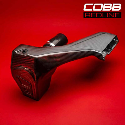 COBB Redline carbon fiber cold air intake system installed in a 2008-2014 Subaru WRX/STI, showcasing sleek design and high-performance components.