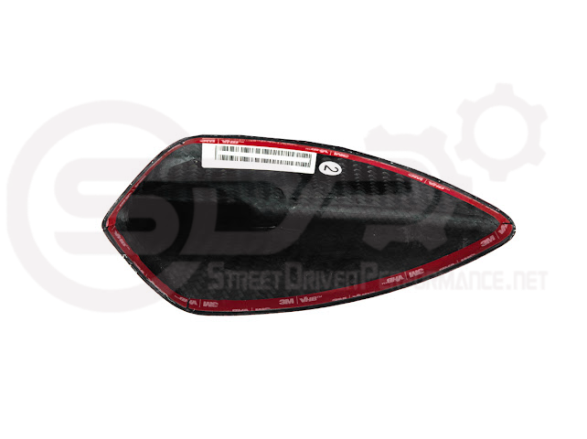 Red carbon fiber shark fin antenna cover for Cadillac ATS, CTS, CT4, and CT5, by Street Driven Performance, mounted on vehicle roof