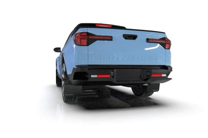 Rally Armor black mud flaps with grey logo installed on a Hyundai Santa Cruz, protecting wheel arches from dirt and debris.