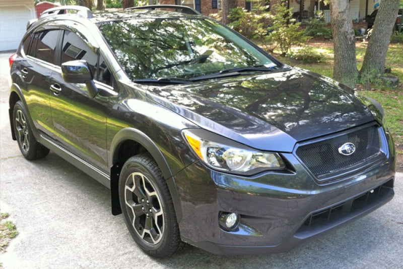 Rally Armor black mud flaps with orange logo on a 2013-2017 Subaru Crosstrek XV, mounted on the wheel well.