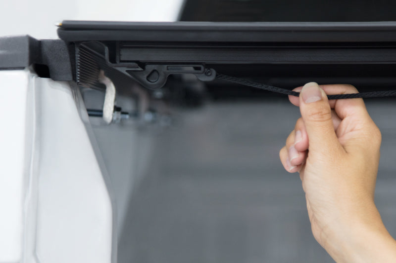 Access LOMAX Pro Series tri-fold hard tonneau cover for 19+ Chevy/GMC 1500 6ft 6in bed in black diamond mist finish.